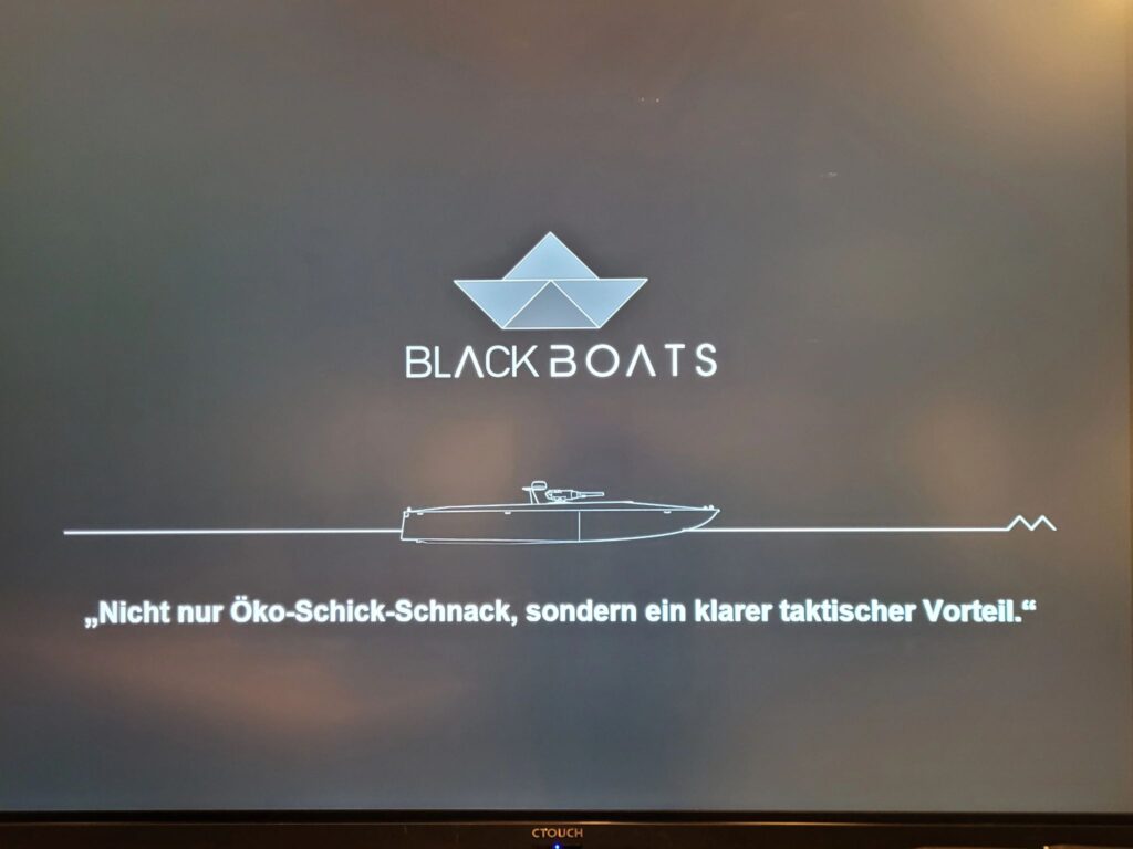 BlackBoats presentation slide at Bundeswehr Symposium 2025 with the quote: “Not just eco-chic frills, but a clear tactical advantage.”